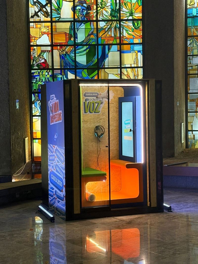 Lit video booth in front of a stained glass window