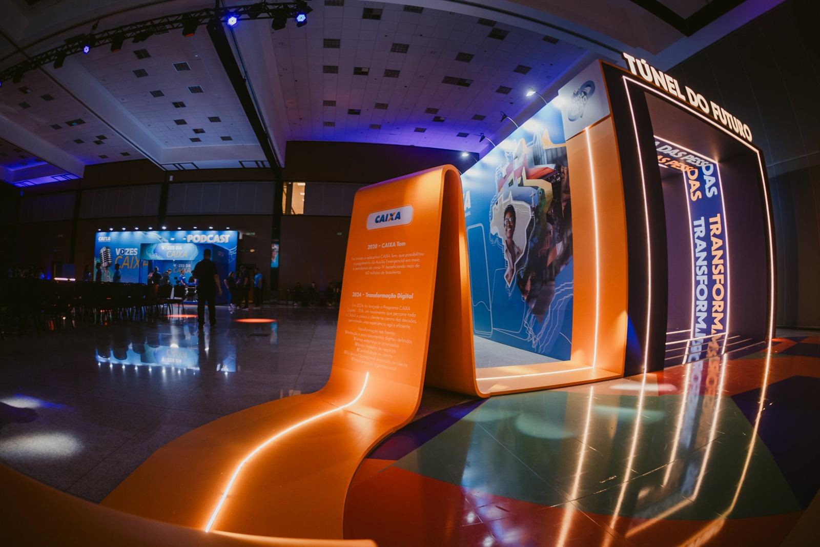 Lit orange timeline ribbon curving into the LED tunnel at the Caixa year-end event